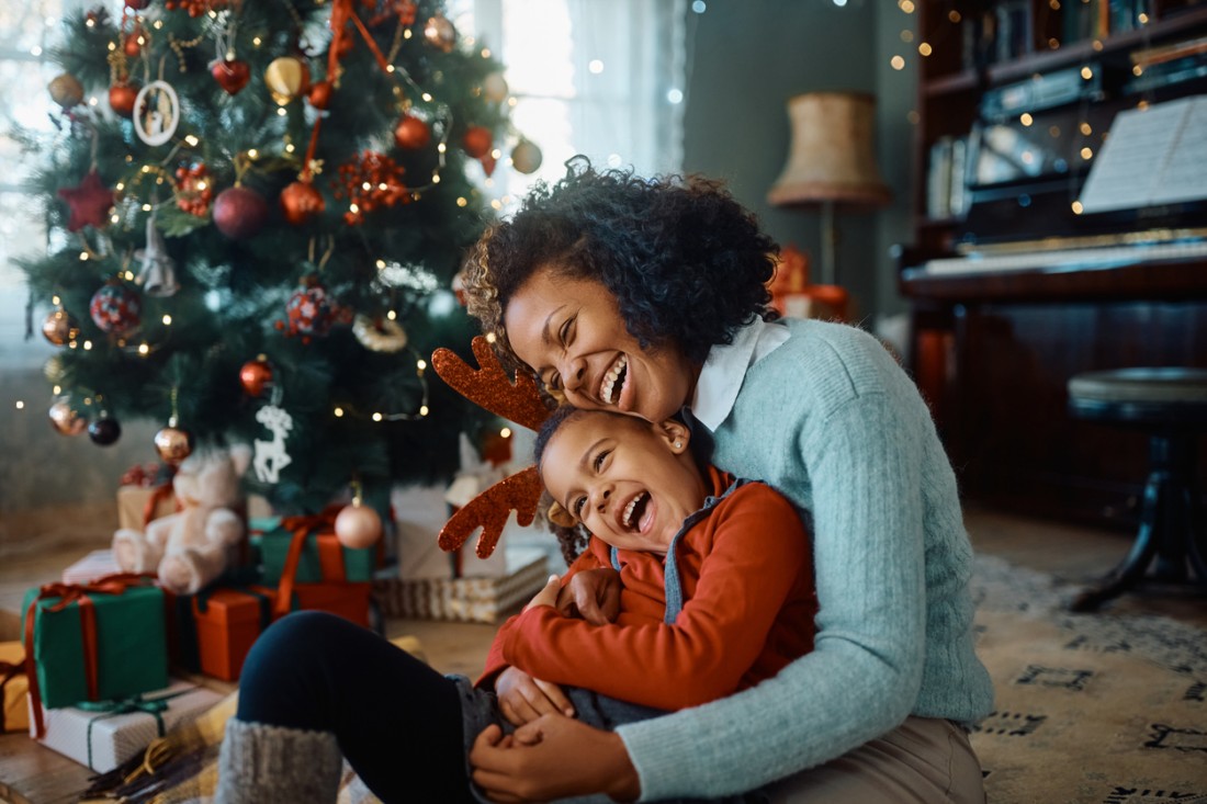 mother and daughter having fun on Christmas day at home in clean indoor air